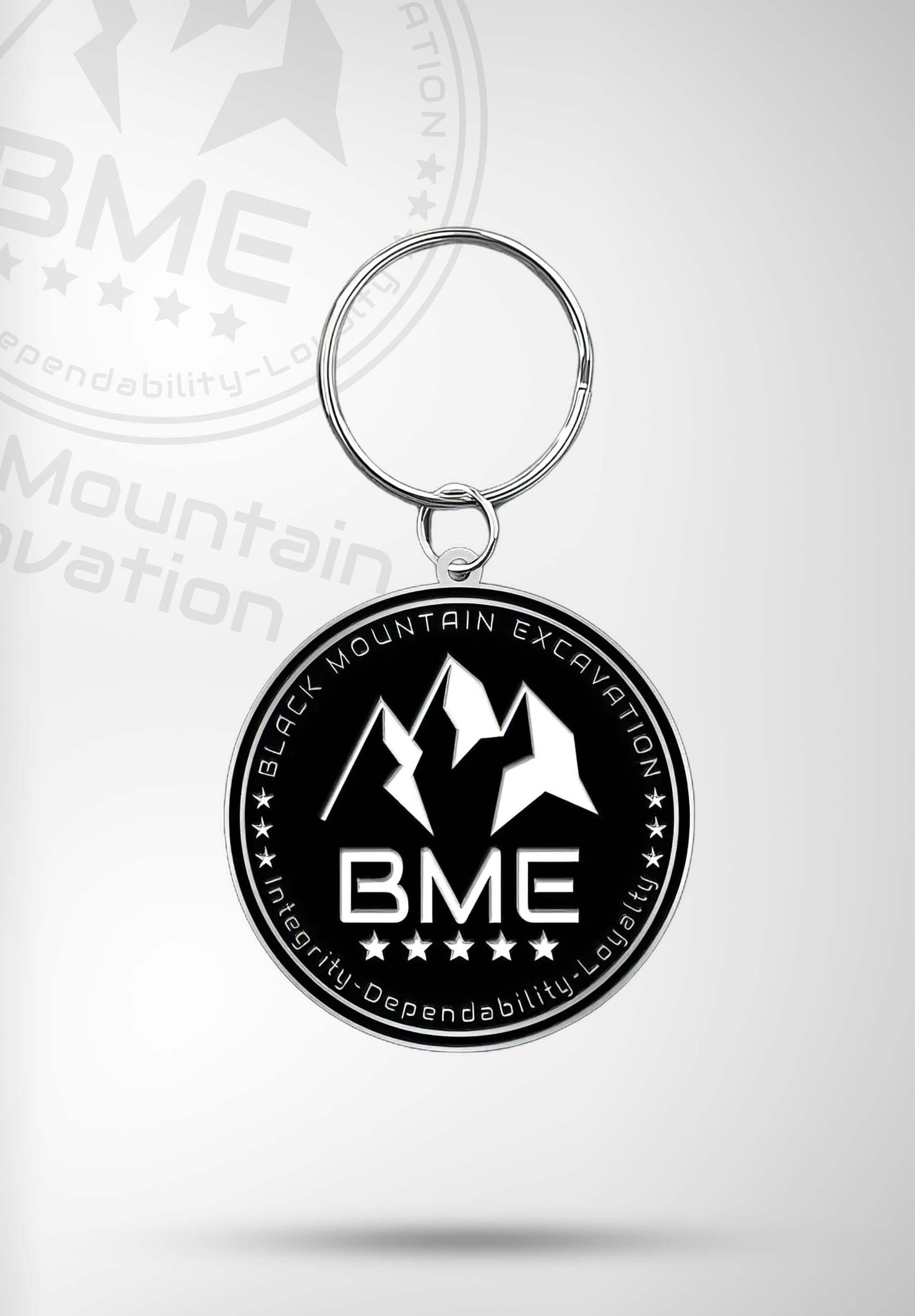 Round black keychain with the BME seal