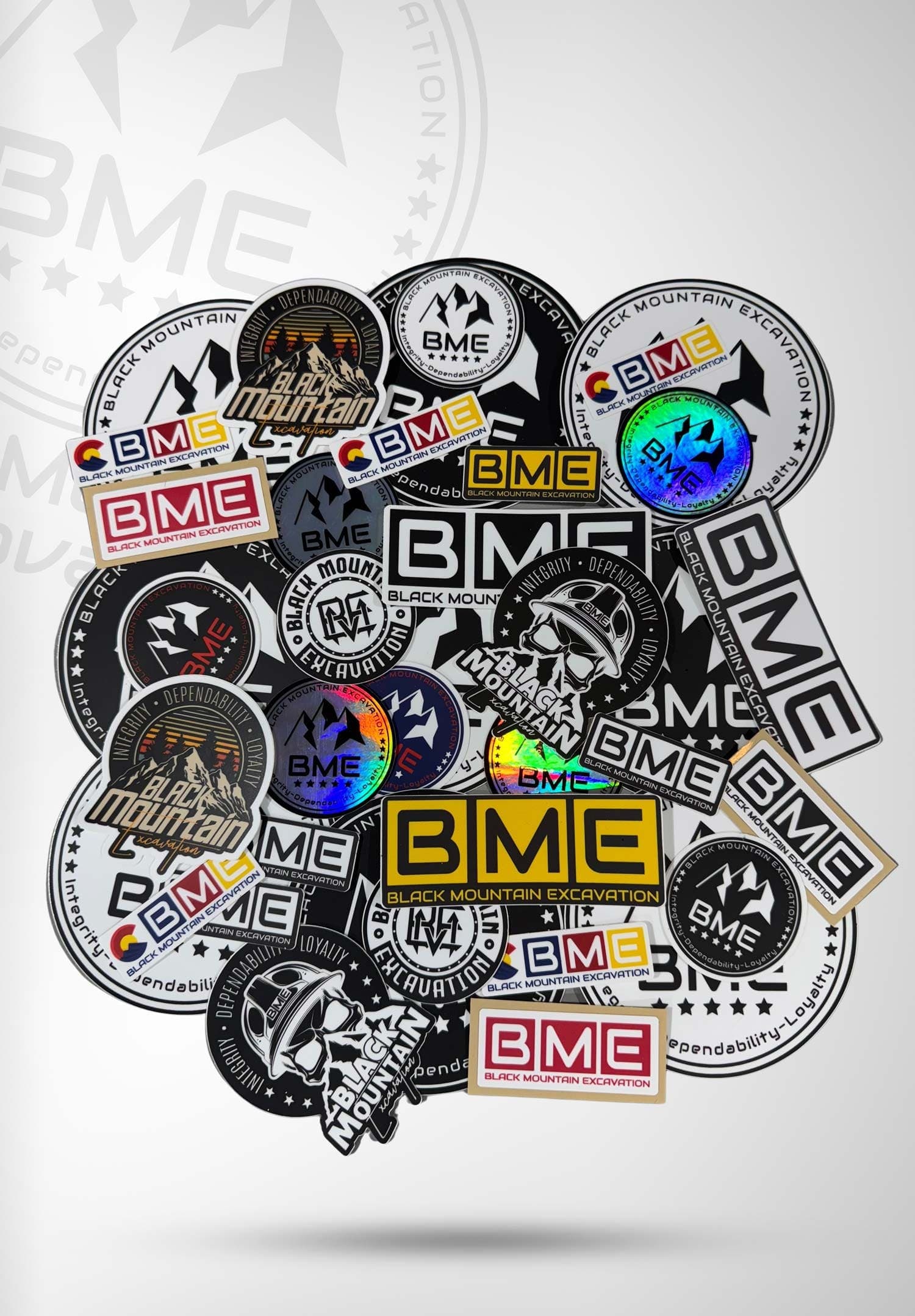 Pile of BME logo stickers in assorted designs
